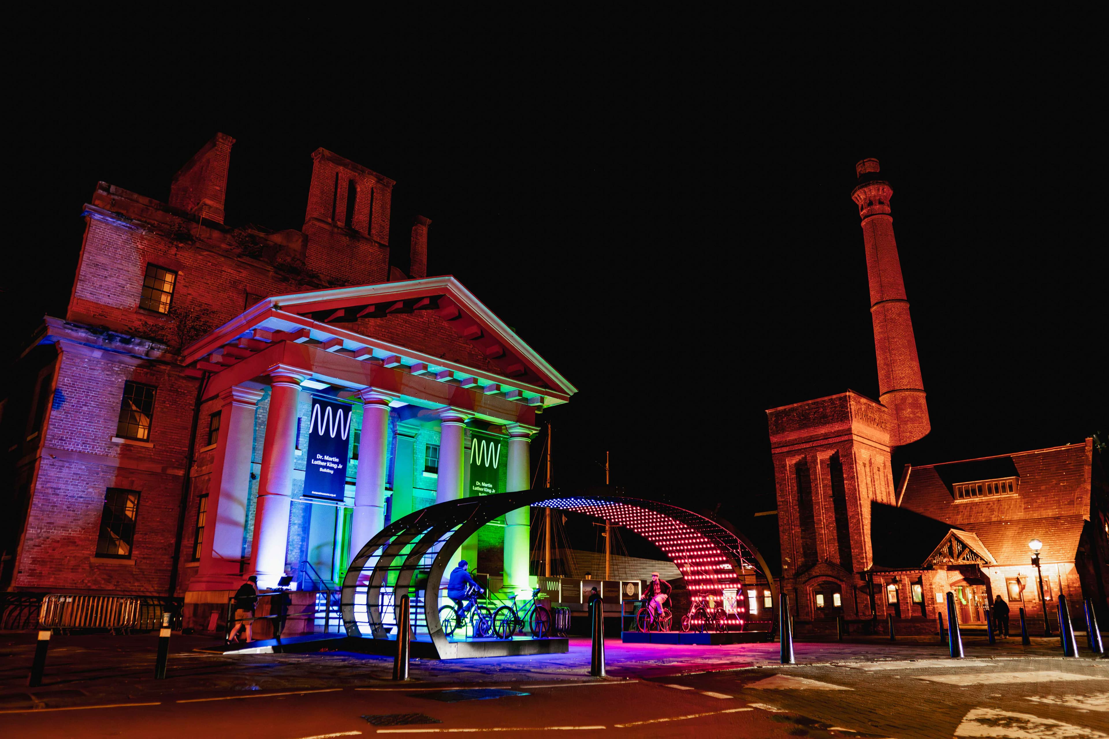 Liverpool River of Light installation featuring illuminated arches with cyclists